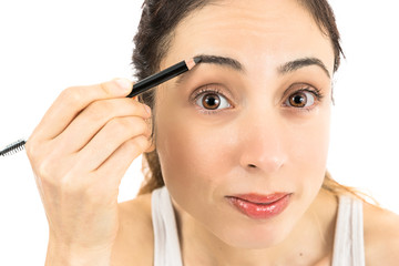 Woman painting her eyebrow
