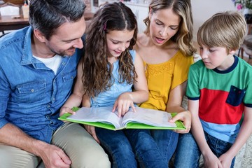 Happy family looking at a photo album