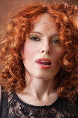 Portrait of beautiful woman with long curly red. Display languag