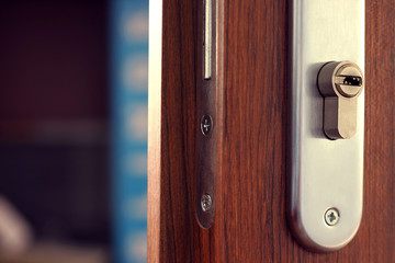 Open wooden door and keyhole