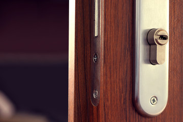 Open wooden door and keyhole