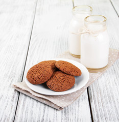 oatmeal cookies and bottles of milk