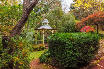Empty beautiful gazebo in lush garden in autumn. Mount Macedon, Victoria, Australia