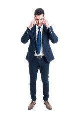 Stressed salesman or broker pressing head on migraine