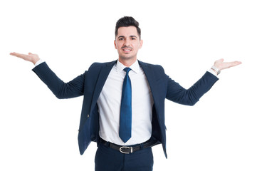 Businessman holding palms up as scale or balance
