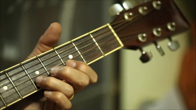 The Old man hand is playing guitar close up