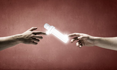 Hand pointing light bulb