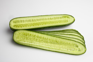 Sliced fresh cucumber on white background from above