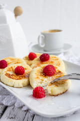 Homemade сottage cheese pancakes with raspberries and honey
