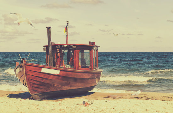 Ein alter Fischkutter am Strand im retro look
