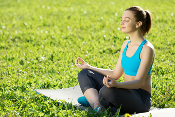 Woman meditating in park