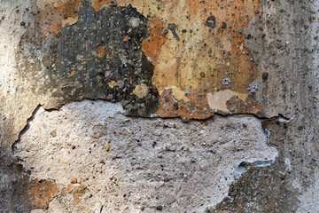 old wall with damaged polychromatic plaster - background