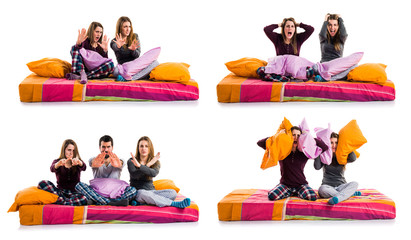 Three friends on a bed making stop sign