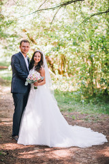 wedding couple. Beautiful bride and groom. Just married. Close up. Happy bride and groom on their wedding hugging. Groom and Bride in a park. wedding dress. Bridal wedding, summer