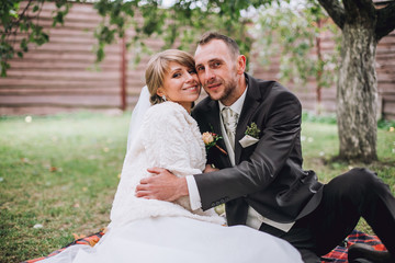 Close up outdoors portrait of beautiful kissing newlyweds.