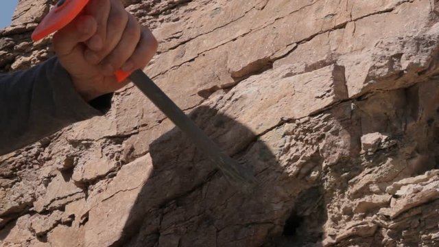 man destroys bedrock using a hammer and chisel
