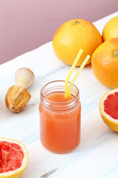 succo di frutta spremuta di pompelmo in barattolo di vetro sfondo colorato