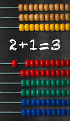 Colorful Wooden Abacus on a Blackboard
