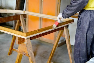 expert Carpenter worker during painting and restoration of an ol