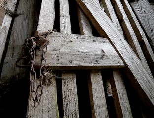 padlock with chain of a broken door of a barn
