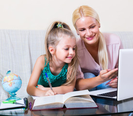 Fototapeta premium teacher and girl studying at home