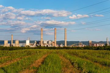 Fototapeta na wymiar Blue cloudy sky over factory - industrial zone, Romania