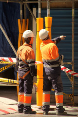 Two workers in a construction site