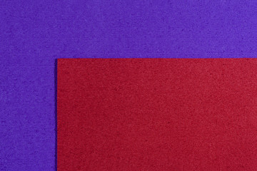Fototapeta premium Eva foam ethylene vinyl acetate red surface on purple sponge plush background