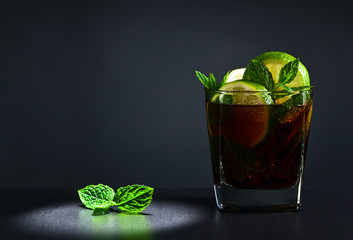  cocktail Cuba libre with lime and peppermint leaves