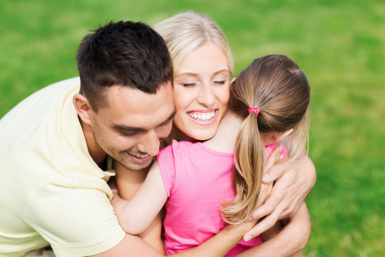 happy family hugging outdoors
