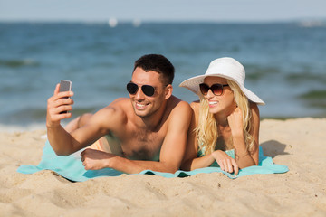 Fototapeta premium happy couple in swimwear walking on summer beach