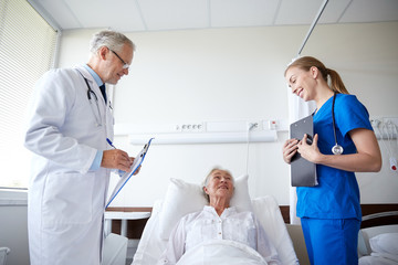 Fototapeta premium doctor and nurse visiting senior woman at hospital