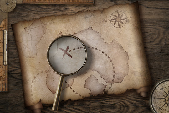 Fototapeta treasure map on wooden desk with compass 3d illustration