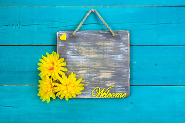 Welcome sign with yellow flowers