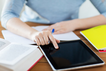 close up of student with tablet pc and notebook