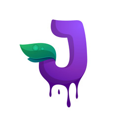 J letter with blueberry juice drops and leaves.