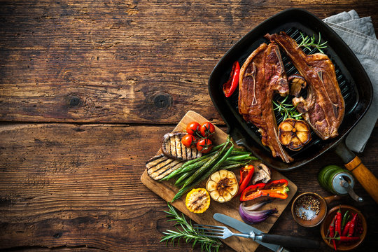 Roasted lamb meat with vegetables on grill pan