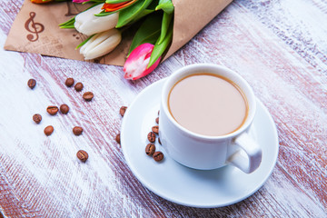 the bouquet of tulips is wrapped in a paper isolated on a wood b