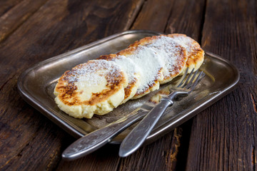Сottage cheese pancakes  on metal plate