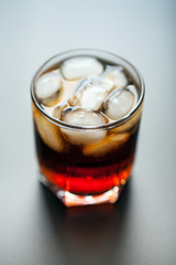 soft drinks. Cola glass with ice cubes on a white background