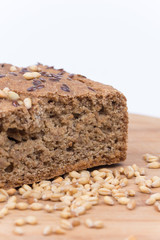 Chrono bread on a wooden board with grains of wheat