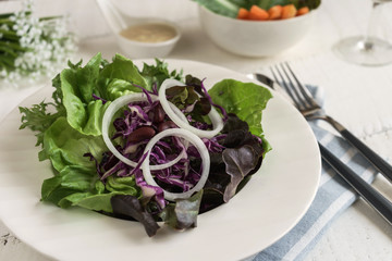 fresh hydroponic salad on white wooden table