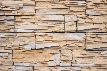 Wall is faced with tiles of  sandstone
