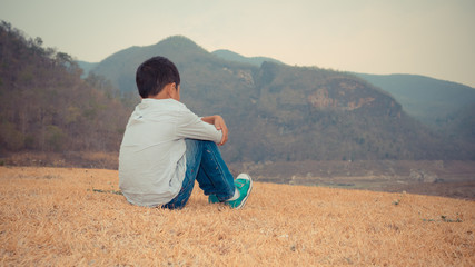 scared and alone, young Asian child who is at high risk of being bullied, trafficked and abused,...