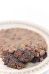 Meatballs with cooked beans on the plate
