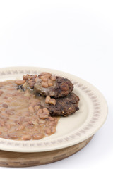 Closeup macro of meatballs with cooked beans