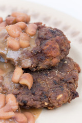 Closeup macro of meatballs with cooked beans