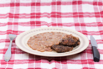Fork knife meatball cooked beans served plate