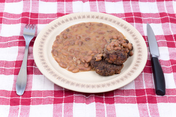 Fork knife meatball cooked beans served plate