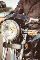 Motorcycle headlights with senior man steering